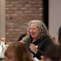 person smiling at table